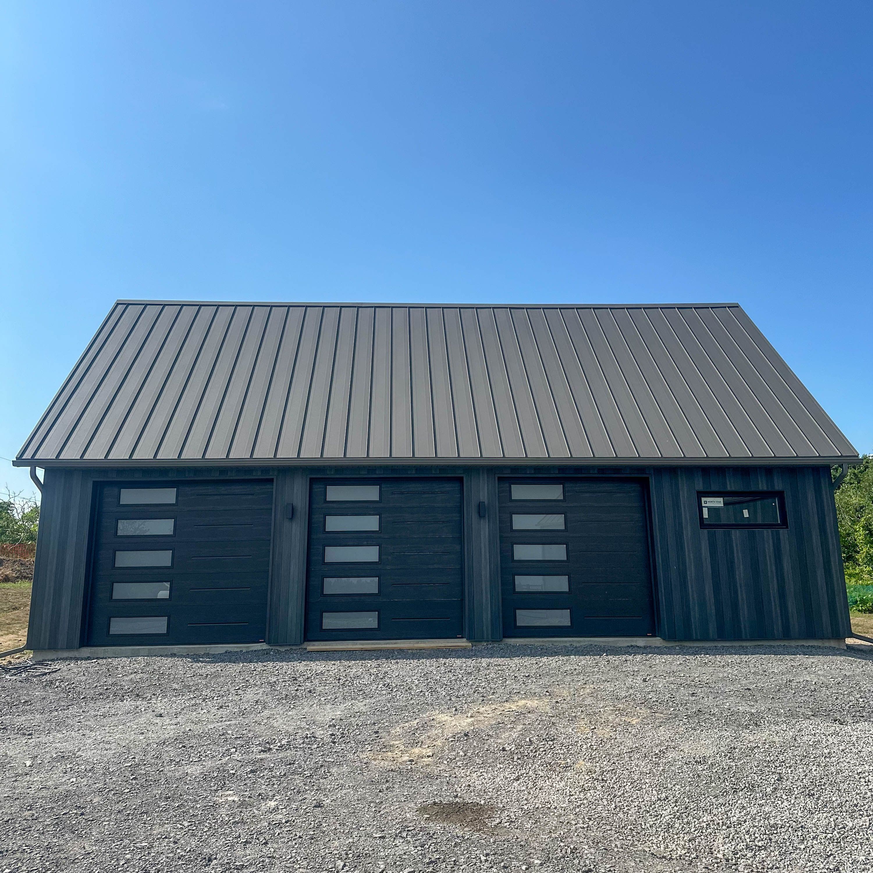 Textured Charcoal Standing Seam Roof with Modern Steel Wood Grain Siding in Roseneath